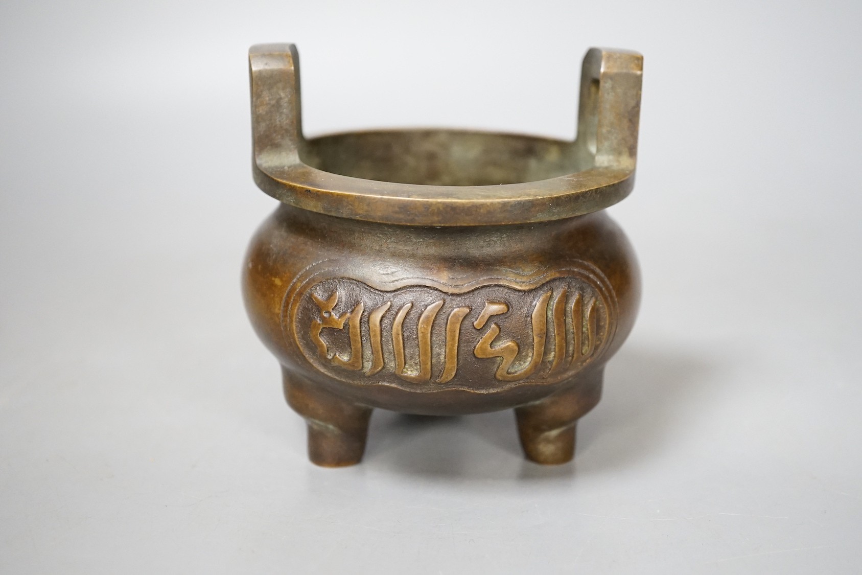 A Chinese bronze tripod Islamic market censer, Xuande mark - 13cm tall